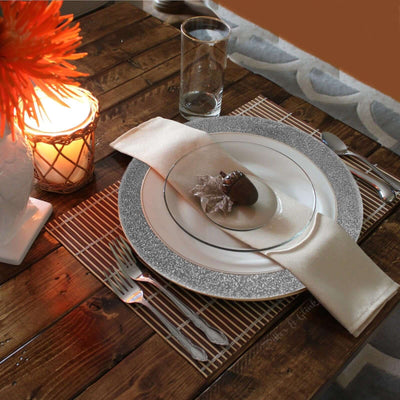 Elegant dinner table setting with decorative plate and napkin.