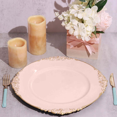 Elegant pink plate with gold trim, surrounded by candles and a floral centerpiece.