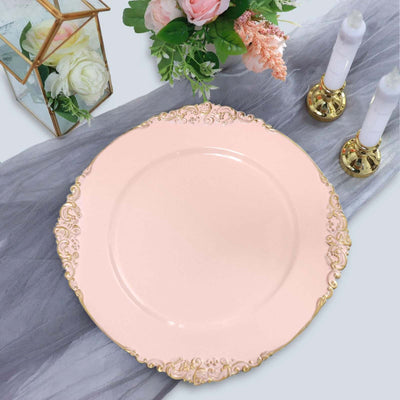 Elegant pink plate with gold rim detailing on a soft gray table setting.