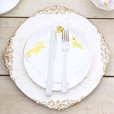 Elegant dining setup with gold-accented plate, silverware, and napkin.