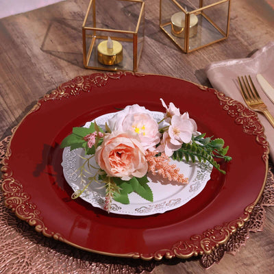 Elegant red charger plate with floral arrangement on vintage white plate.