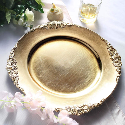 Elegant gold decorative plate on a soft fabric backdrop.