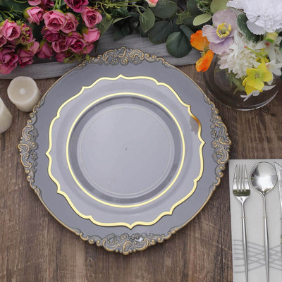 Elegant gray decorative plate with gold accents on a rustic wooden table.