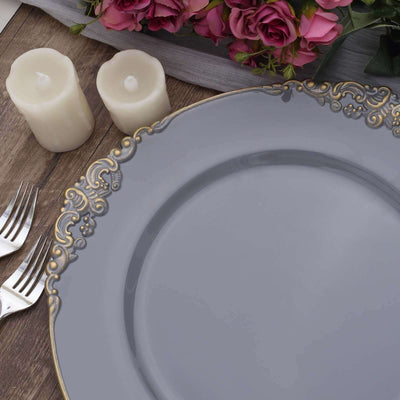 Decorative gray plate with gold trim, surrounded by candles and flowers.