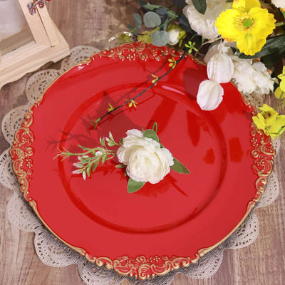 Red decorative plate with gold trim and a white flower on a textured surface.