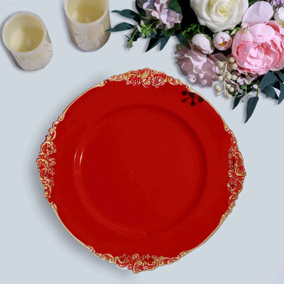 Red decorative plate with ornate gold rim and floral arrangement