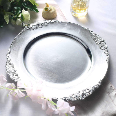 Elegant silver serving platter with ornate edges, set on a soft tablecloth.