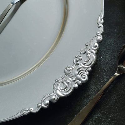 Elegant silver plate with intricate decorative edge detail.