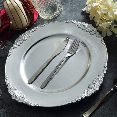 Elegant silver-plated charger plate with knife and fork set, perfect for dining.