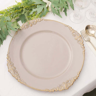 Elegant round dinner plate with ornate gold trim on a table setting.