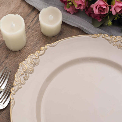 Elegant dinner plate with ornate gold detailing, surrounded by candles and flowers.