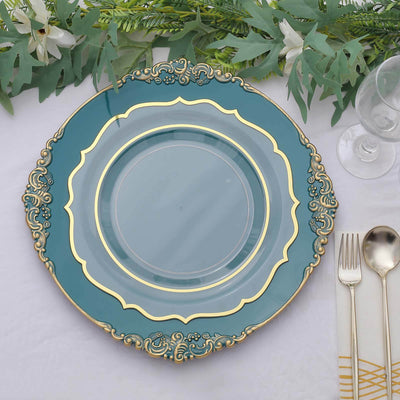 Elegant teal plate with gold detailing, surrounded by greenery and silver cutlery.