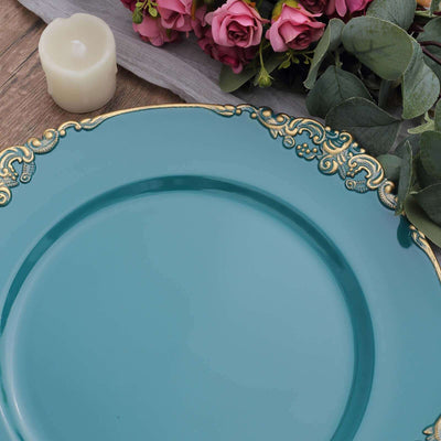 Decorative turquoise plate with gold accents, surrounded by flowers and a candle.