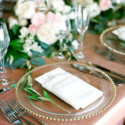 Elegant table setting with floral arrangements and fine dining utensils.