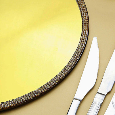 Elegant gold serving tray with sparkling rhinestone edge and silver cutlery.