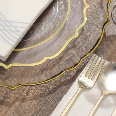 Elegant gold-rimmed dinnerware set with napkin on rustic wooden table.