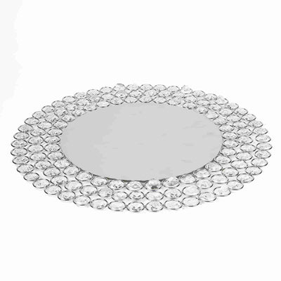 Decorative round mirror with crystal embellishments on a white background