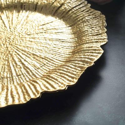 Gold textured decorative plate with a scalloped edge.