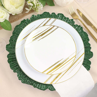 Elegant green and white plate set with gold accents on a table setting.