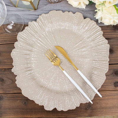 Elegant textured beige plate with gold fork and knife, styled on a wooden table.