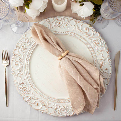 Elegant decorative plate with a napkin and holder, set on a dining table.