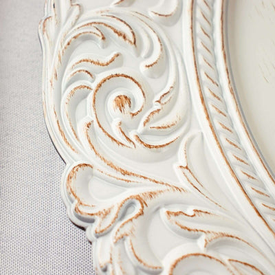 Ornate white picture frame with intricate detailing