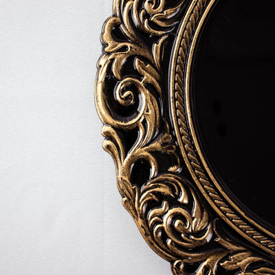 Ornate gold-framed mirror with intricate detailing