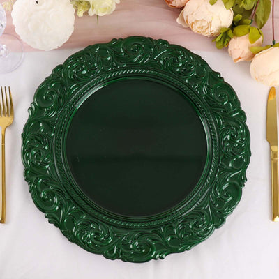 Green ornate charger plate on a table setting with flowers.