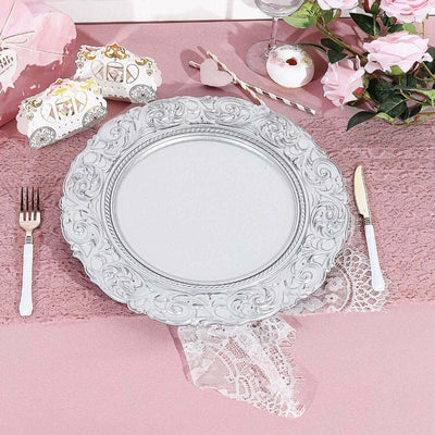 Elegant silver decorative plate on a pink lace table setting.