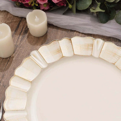 Elegant scalloped edge plate with gold trim on a rustic wooden table.