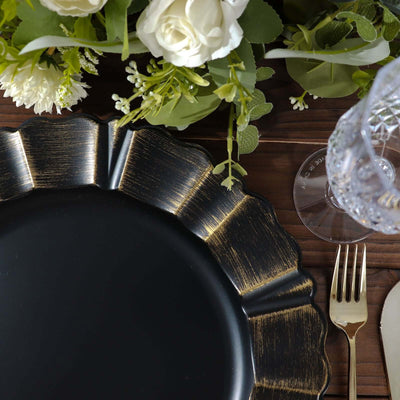 Elegant black plate with gold accents on a wooden table setting.