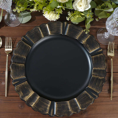 Black and gold decorative plate on a wooden table with elegant setting.