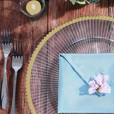 Elegant table setting with a blue envelope and floral accent.