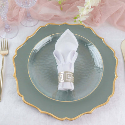 Elegant green plate with a white napkin and decorative napkin ring on a table setting.