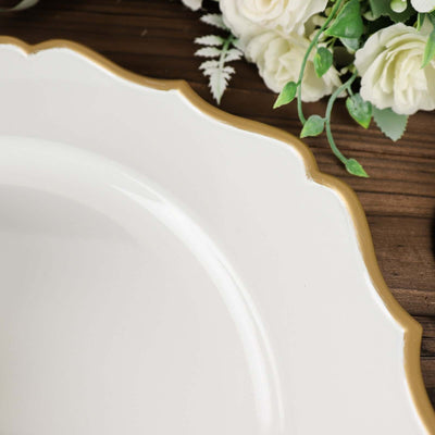 Elegant white plate with gold rim detail on wooden surface.