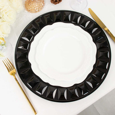 Elegant black and white dinner plate set on a table with gold utensils.