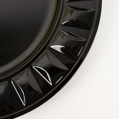 Black decorative plate with textured rim detail.