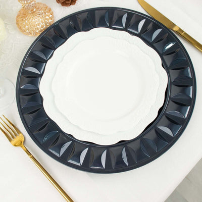 Elegant navy and white dinner plates stacked on a table with gold cutlery.