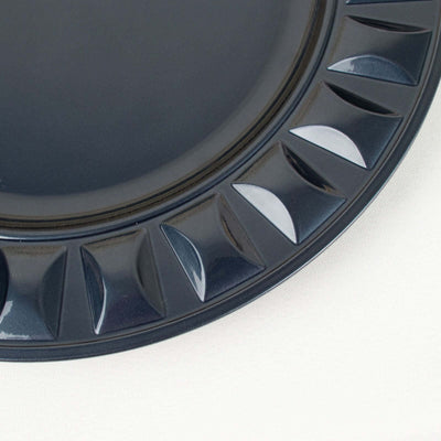 Dark blue decorative plate with a textured rim design.