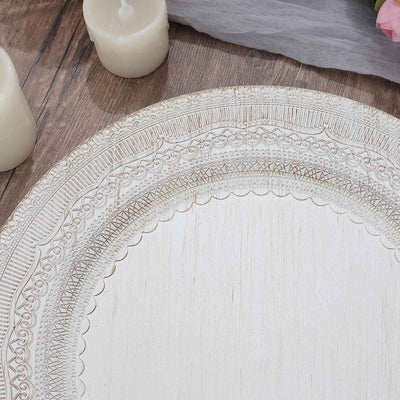 Decorative white plate with intricate design on wooden table