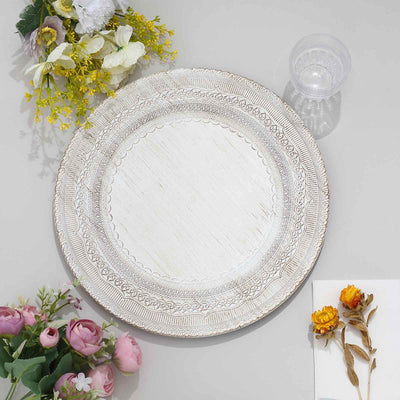 Decorative white plate with intricate border design, surrounded by floral accents.