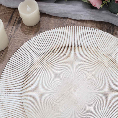 Textured white decorative plate on wooden surface.