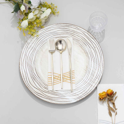 Elegant round plate with cutlery and napkin, styled with flowers.