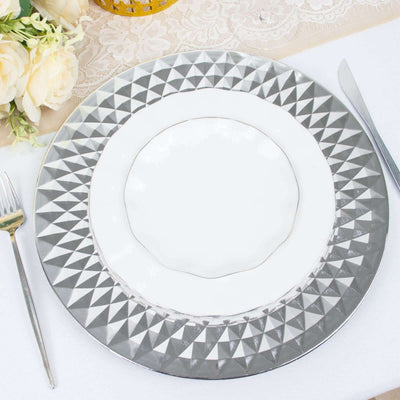 Elegant silver charger plate with intricate geometric design.