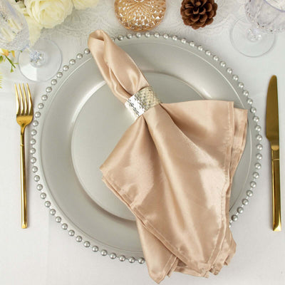 Elegant beige napkin elegantly wrapped on a decorative plate setting.