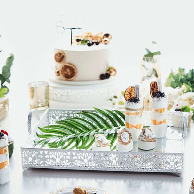 Elegant dessert display with tropical accents on a decorative tray.