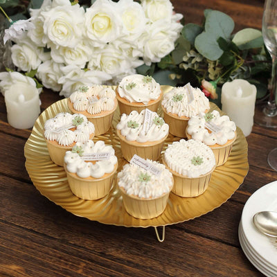 Elegant assortment of decorative cupcakes on a gold platter.