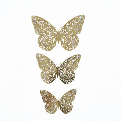 Gold decorative butterflies in ornate designs, showcasing intricate details.