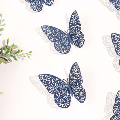 Decorative navy blue paper butterflies on a white background.