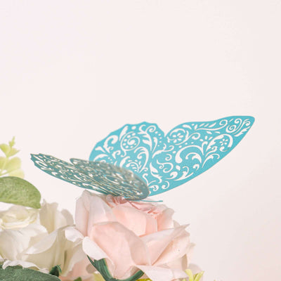 Teal decorative butterfly atop pink flowers